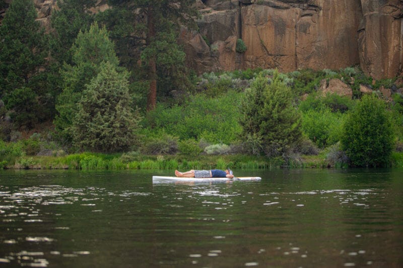 A man relaxing and floating on the river