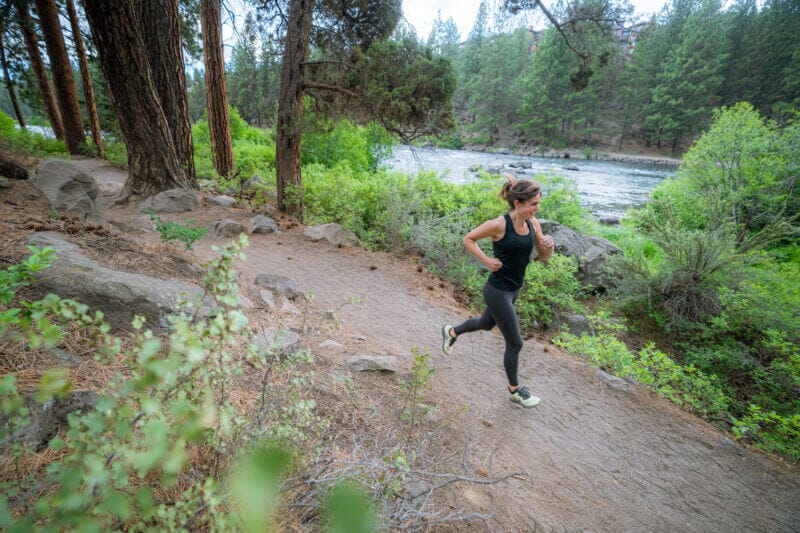 Woman running in the forest - Mission Farms CBD