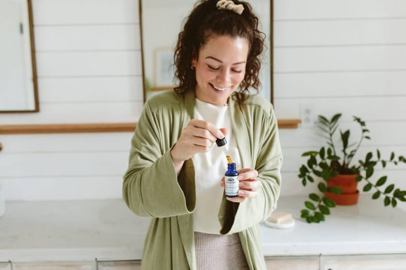 a woman about to use relax cbd oil from mission farms cbd